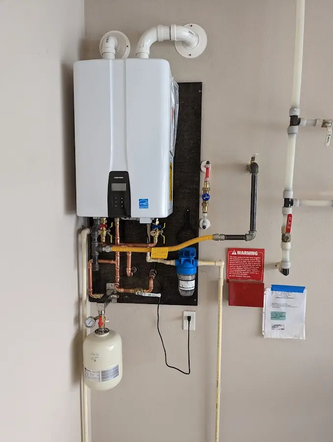 Professional plumber installing copper piping in a Laramie home